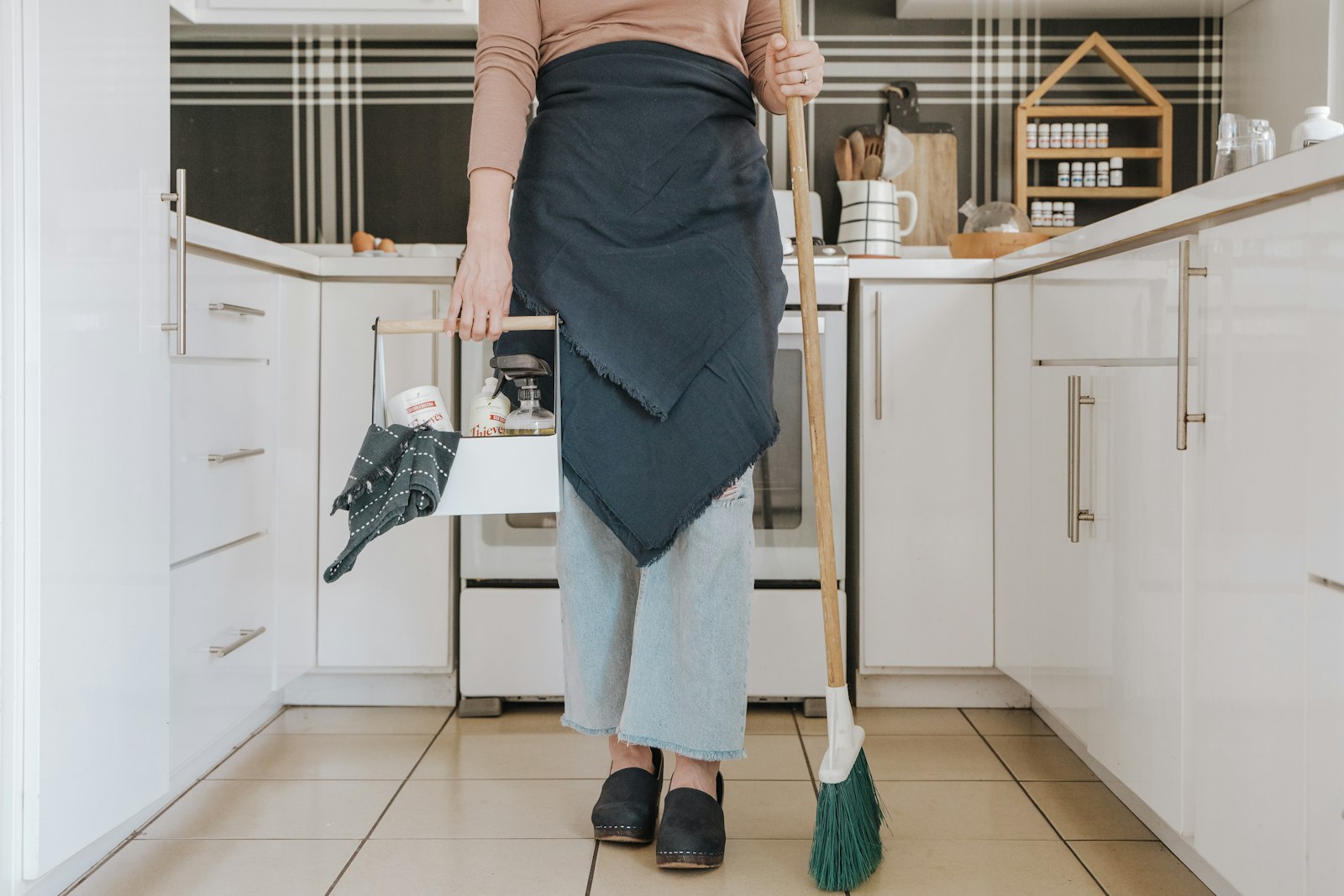 Cleaning team member smiling in a bright kitchen